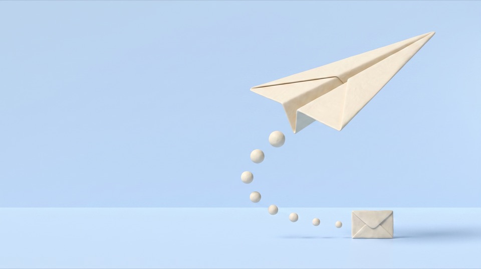 A clay paper plane climbing from an envelope on the floor, leaving a trail of small clay balls