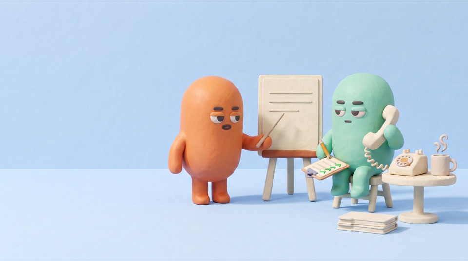 An orange clay figure pointing at a blank card on an easel while a mint figure on a stool listens on a telephone with a ticked clipboard
